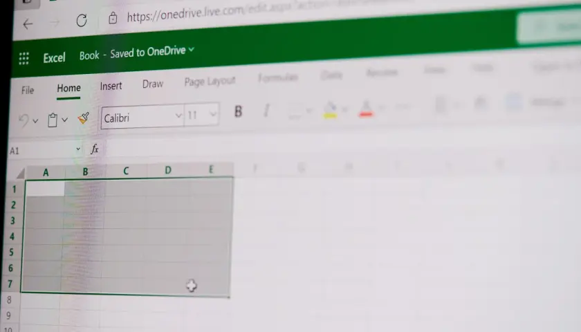 Ekran Excel Online z pustym arkuszem, gotowym do wprowadzania danych. Widoczne paski narzędzi i pole formuły, które ułatwiają pracę z funkcjami tablicowymi Excel.